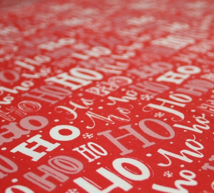 Red fabric with 'HO HO HO' pattern and Textile Plaza logo.