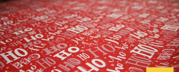Red fabric with 'HO HO HO' pattern and Textile Plaza logo.